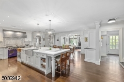 Stunning oversized Marble Island with large butcher bloc, 6 Burner Wolf Range with double ovens & oversized metal hood, Subzero Refrigerator with freezer drawers, additional refrigerator drawers.