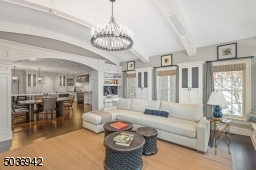 Enjoy the timeless elegance of this phenomenal family room with custom builtins, desks for home work & unique high ceiling