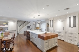 Timeless Kitchen with custom wood cabinets with & desk, beautiful wood floors with radiant heat.