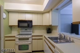 Kitchen with pass through into dining room .