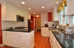 Custom soft white cabinetry, granite countertops, new 2011 appliances and hardwood floors