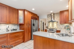with solid cherry cabinets, SS appliances, Ceasarstone counter