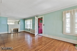 Gorgeous hard wood floors add ambiance to the spacious living room.
