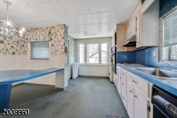 Large eat in kitchen with many windows and access to the screened in porch.