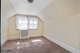 A sizable bedroom/home office with large windows make a great place to work or just relax.