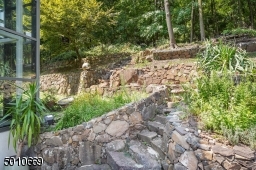 Contemporary Gem in Millburn with a 28 ft glass and steel addition and the South Mountain Reservation in your backyard!