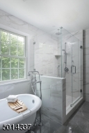 Featuring soaking tub and frameless shower door