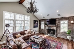 Family Room with lots of light, wood burning fire place, hardwood floors, entrance to deck.