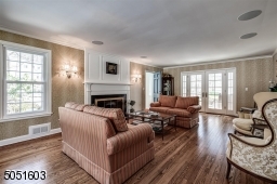 Living Room with hardwood floors & fire place, Doors leading to deck.