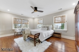 Bedroom 2 is en-suite with hardwood floors, base moldings, crown moldings