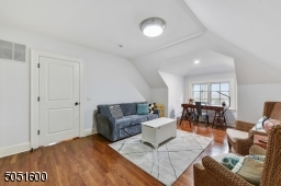 Bedroom 5 with baseboard molding, crown molding, vaulted ceiling, and closet