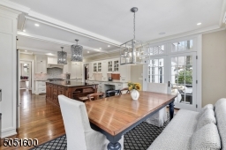Eat-In area with double French doors to patio, three exposures of windows and built-in work area with glass display cabinets.
