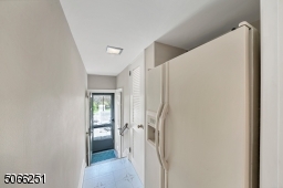Hallway to powder room, pantry and patio.