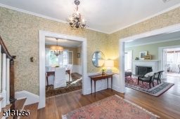 The foyer makes a wonderful first impression with lovely wallcoverings and a bold chandelier