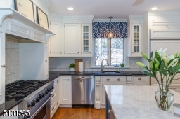 Chefs will love the dream kitchen and breakfast room featuring bright windows, custom cabinetry, a large center island and high-end Viking and Sub-Zero stainless steel appliances.