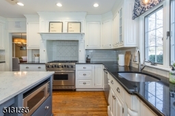 Chefs will love the dream kitchen and breakfast room featuring bright windows, custom cabinetry, a large center island and high-end Viking and Sub-Zero stainless steel appliances.