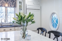 Chefs will love the dream kitchen and breakfast room featuring bright windows, custom cabinetry, a large center island and high-end Viking and Sub-Zero stainless steel appliances.