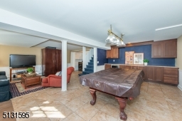The home's fully finished walk-out lower level includes an expansive rec room, laundry and storage.