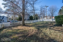 An oversized two-car attached garage and wide driveway, landscaping and a charming faade with dormer windows add excellent curb appeal