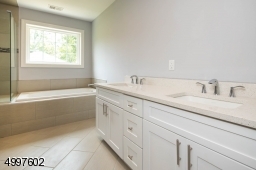 Dual sinks and contains an extra door for added privacy.