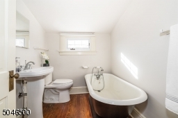 Full bath on 3rd floor with large soaking tub and hardwood floor