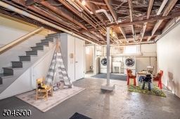 High ceiling can easily be finished in this dry basement w/toilet, laundry, storage, utilities and workshop