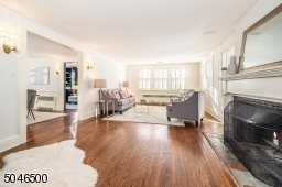 Sun-filled living room w/2 seating areas and walls of windows.