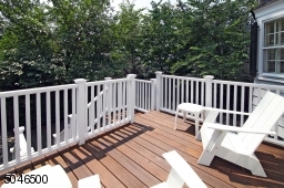 Deck off of the kitchen overlooks the driveway and backyard.