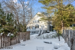 In the snow, a view of the back of the house from the back of the winter garden