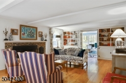 FORMAL LIVING  WITH WOOD BURNING FIREPLACE OPENS TO ENTRANCE  ENTRANCE HALL AND OFFICE