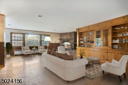 The picture window overlooks a beautiful wooded backyard.