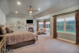 Tasteful Master Suite with gas fireplace, sitting area & lots of natural light.