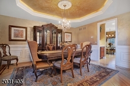 Inlayed hard wood floor and tray ceiling with accent lighting and a bulter pantry