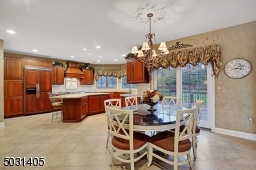 Gourmet kitchen with separate dining area with sliders out to a deck