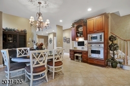 Dining area of kitchen showing back staircase, extra ovens - also there a two large pantries