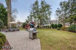 Hand set stone patio makes this yard a great place for outdoor entertaining