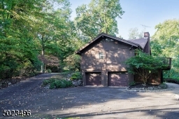 View of side with 2 car attached garage and driveway to front of home.