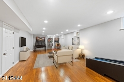 Recreation Room with premium wood-look vinyl flooring, recessed lights, two double closets with shelves and a third walk-in  closet