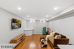 Media Room with built-in work spaces, recessed lights and premium wood-look vinyl flooring