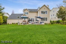 Rear yard features a cobblestone Paver Patio leading to flat, grassy yard