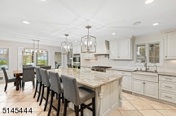 Eat-In Chef's Kitchen features stone floors, recessed lights, new modern light fixtures, high-end appliances including two 36 inch SubZero refrigerator / freezer, Wolf double wall ovens & Wolf six burner stove top.