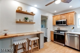 Updated kitchen with gorgeous maple cabinetry and modern breakfast bar.