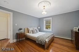 Bedroom 2 featuring hardwood floors and a walk-in closet
