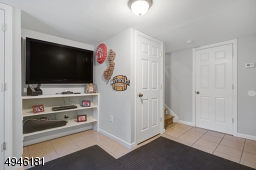 Family Room is serviced by a full bath & offers access to the attached garage.