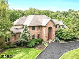 Circular driveway takes you to this stunning 3 sided brick home with a beautiful custom Mahogany front door.