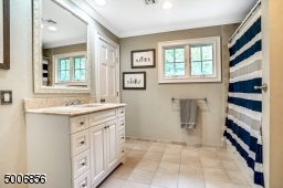 This full bath with heated flooring belongs to Bedroom #5.