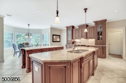 One of the nicest kitchens i've seen. heated flooring, granite and limestone counter tops, and a wall of windows bringing the outside in. Don't forget the desk!
