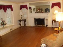 With hardwood floors, wood burning fireplace, and a bay window