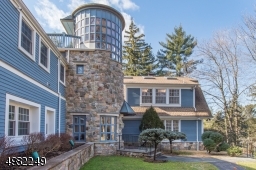 Located on 1.5 acres of wooded land on cul-de-sac in desirable Pine Way Farms, this nearly 8000 sq ft home sits high above the long welcoming driveway w/ utmost privacy & grandeur.
