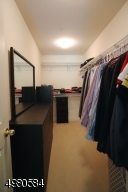 A walk in closet provides ample room for you wardrobe.